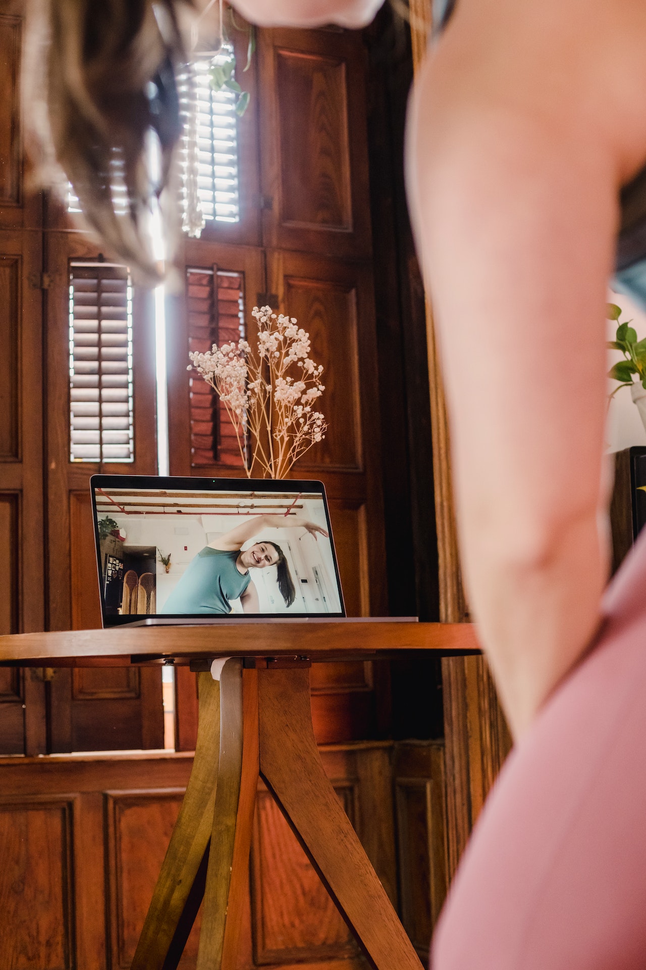 Woman exercising at laptop